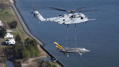 CH-53K King Stallion lifting a light armored vehicle during amphibious exercise