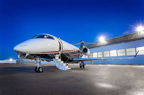 Challenger 350 private jet taxiing on tarmac in sunrise light