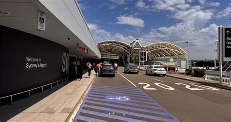 Charleston International Airport drop-off area with signage and travelers unloading luggage