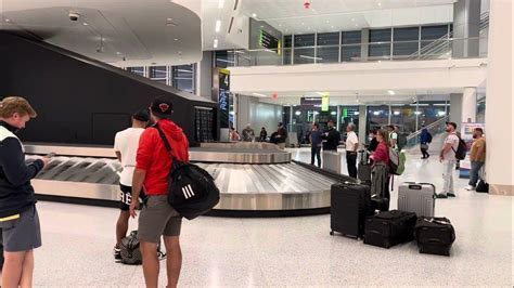 Checked luggage on a baggage carousel in Newark Airport Terminal B