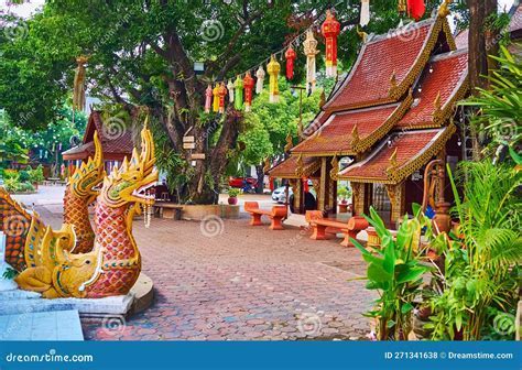 Chiang Mai temple grounds with tourist safety signs and volunteer guides