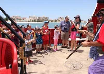 Children laughing during a water gun battle on the forward deck of Captain Memo’s Pirate Cruise