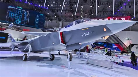 Chinese J-20 stealth fighter pilot near aircraft shelter