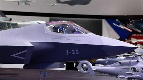 Chinese naval J-35 stealth fighter taxiing at dusk on carrier deck