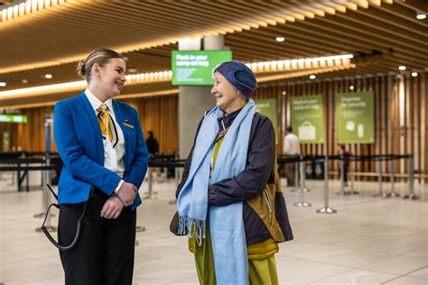 chinese tourists arriving at auckland international airport smiling with souvenirs