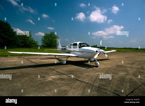Cirrus SR22 parked at regional airfield with sunset backdrop