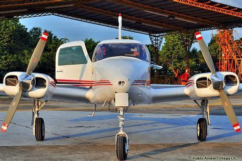 classic cessna 310 twin engine parked on tarmac under sunset light