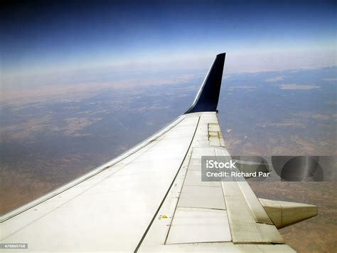 close-up of airplane wing with visible curvature and airflow