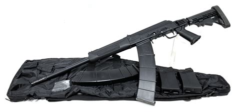 Close-up view of Saiga semi-automatic shotgun mounted on Yak-52B2 wing pylon