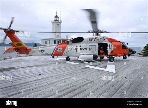 Coast Guard Air Station Sitka MH-60 Jayhawk Alaska rescue helicopter over rugged southeastern Alaska coastline