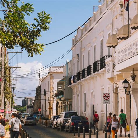 colonial streets of santo domingo at sunset with people walking