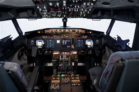 commercial aircraft cockpit with pilot crew and illuminated flight instruments