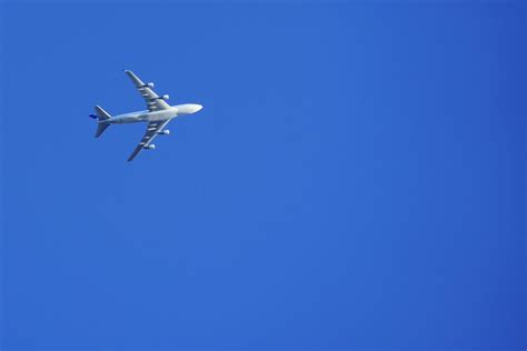 commercial aircraft flying in clear sky without contrails at high altitude