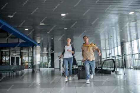 congested airport terminal with passengers rushing to gates