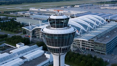 control tower at busy European airport under stormy skies