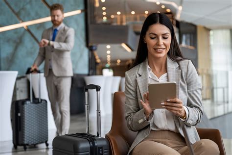 corporate traveler working on laptop in premium economy cabin daylight