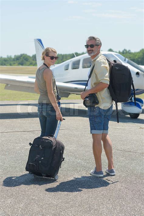 couple boarding a small plane for sunset romantic flight from regional airport