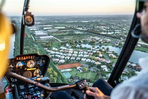 couple taking a helicopter ride over Disney for a marriage proposal at sunset