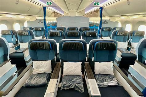 crowded air austral economy cabin on full flight with minimal overhead storage