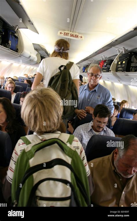 crowded airplane boarding line passengers waiting jet bridge congestion