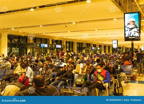 crowded departure hall at Dubai International Airport during flight cancellations