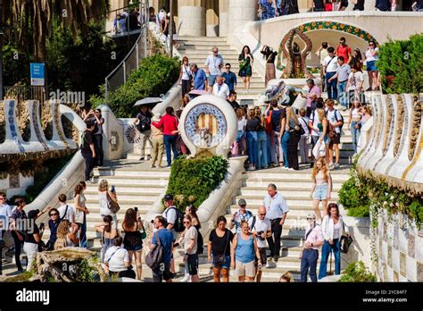 crowded tourist street in Barcelona with signs calling for tourism reform
