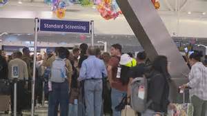 crowded TSA security line overwhelmed officers airport passengers