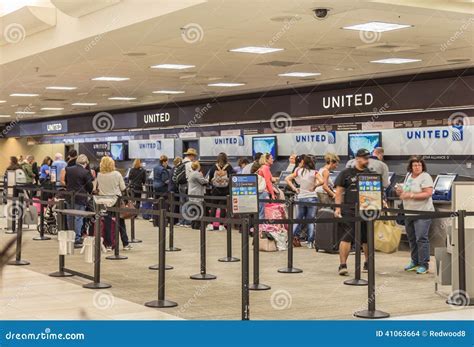 Crowded United Airlines check-in counters during peak summer season