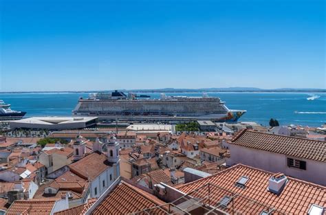 cruise ship near Lisbon’s Santa Apolónia terminal with smog surrounding local skyline