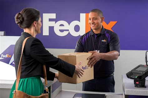 customer at FedEx checkout counter finalizing payment and preparing shipment