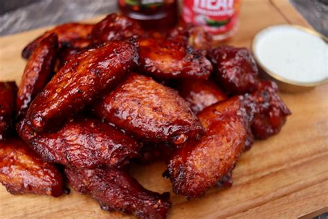 Daly’s Pub grilled sweet heat wings plated with microgreens and house sauce