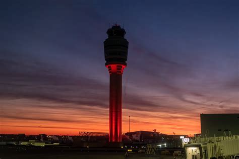 dark storm clouds over ATL control tower as thunderstorms shut down flights
