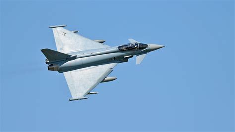Dassault Rafale and Eurofighter Typhoon parked on military airfield