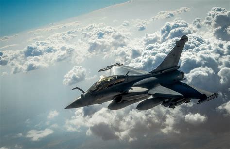 Dassault Rafale ascending vertically through low cloud cover