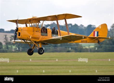 De Havilland DH 82A Tiger Moth biplane in flight over countryside
