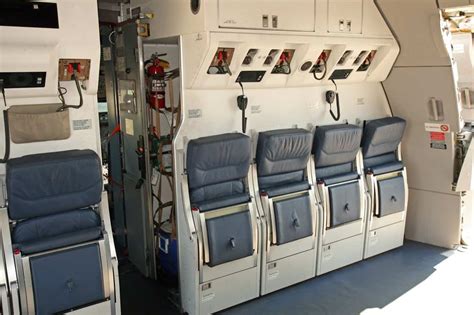 deadhead pilot assisting flight crew during emergency drill at training facility