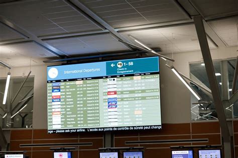 delayed departures board showing multiple U.S. flights from Canadian airports