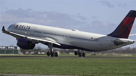 delta air lines airbus a330neo taking off in overcast winter weather