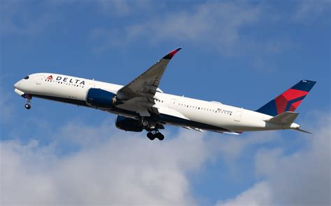 Delta Air Lines aircraft at ATL concourse with passengers boarding