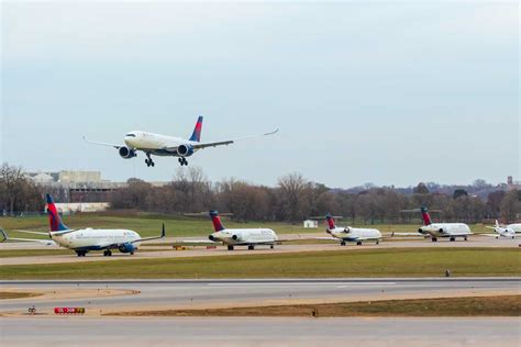 delta air lines aircraft lined up at minneapolis-st paul airport during sunrise