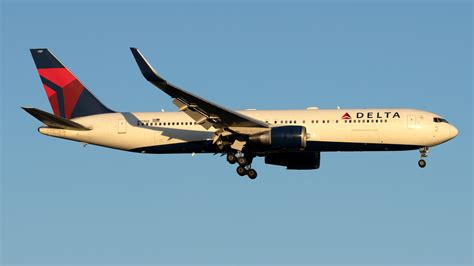 Delta Air Lines Boeing 767-300ER departing from JFK at sunset