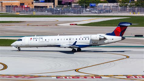 Delta Air Lines CRJ550 boarding passengers at regional gate premium service rollout