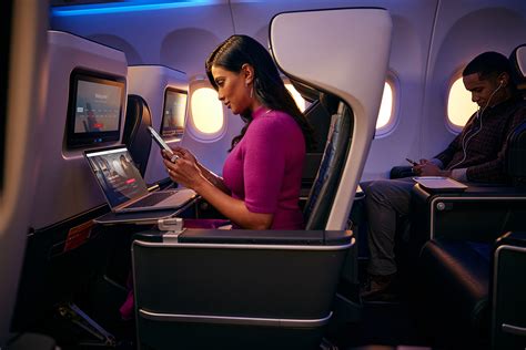 Delta Air Lines passenger using free T-Mobile inflight WiFi smartphone cabin