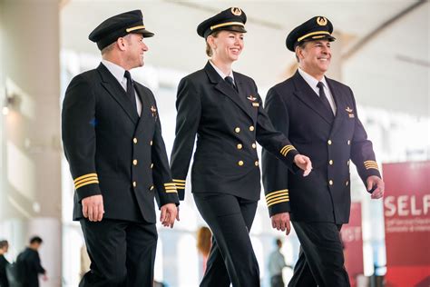 Delta Air Lines pilots walking through an airport terminal