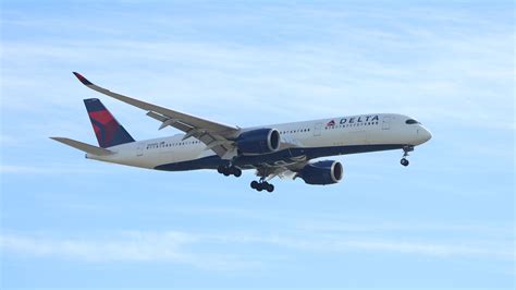 Delta Airbus A350 parked at international terminal during sunset