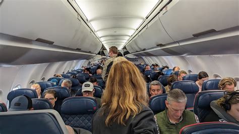 Delta aircraft boarding full flight overhead bins passengers aisle congestion
