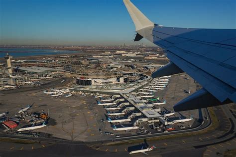 Delta aircraft taxiing at JFK airport with Manhattan skyline in background