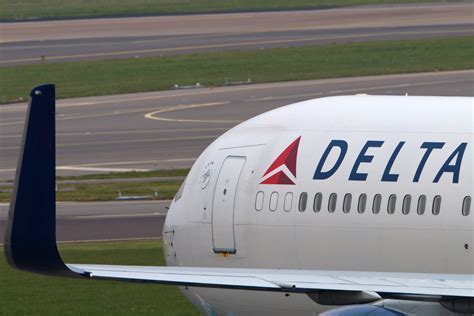 delta airlines boeing 767 parked with nfl team boarding