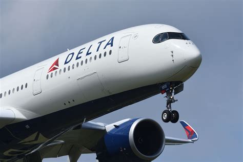 delta airlines jet exterior with passenger boarding through rear stairs marked basic main