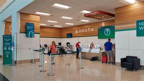 Delta customer service desk assisting rebooked travelers at Tokyo Haneda